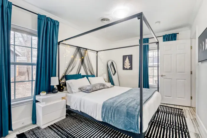 Bright and relaxing primary suite with large windows and a comfortable queen bed
