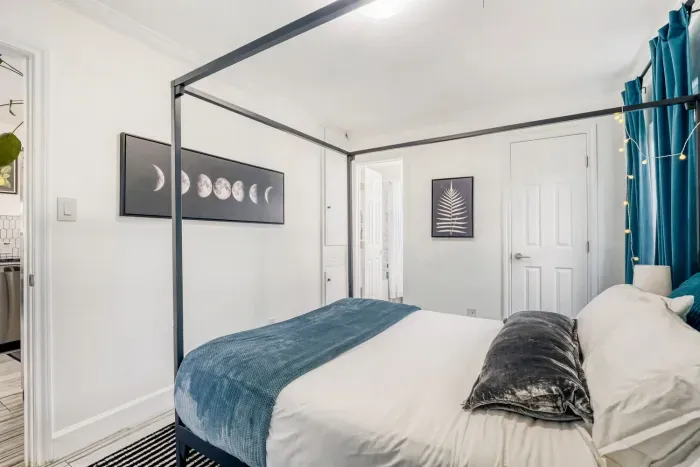 Elegant canopy bed with soft string lights creating a calm, cozy atmosphere