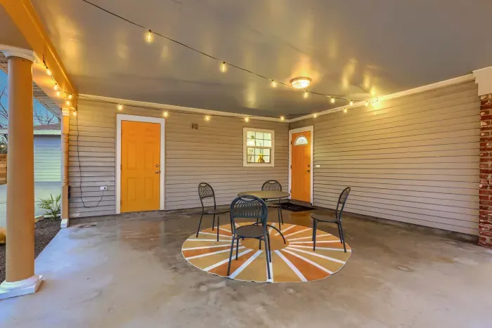 Covered porch seating area with café table, ideal for morning coffee or evening drinks