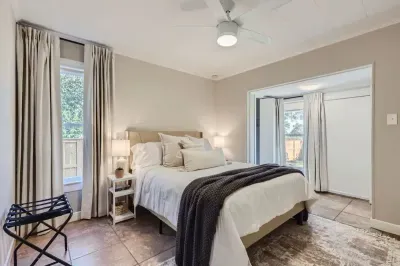 Bright and cheerful bedroom with a large bed and plenty of natural light.