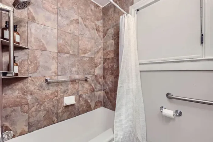 Bright and fresh bathroom with a combination tub and shower, perfect for unwinding.