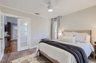 Bright and airy bedroom with large windows and blackout curtains for ultimate comfort.