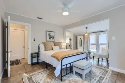 Modern bedroom with minimalist design and high-quality bedding.