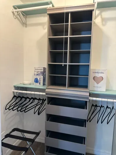 Well-lit laundry room with ample shelving, making it easy to organize laundry supplies and keep everything neat.
