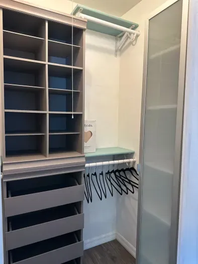 Smartly designed laundry closet with shelving and storage space, ideal for keeping laundry essentials in order.