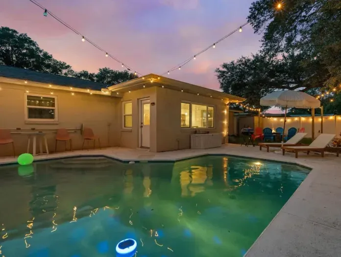 Serenity meets style in our backyard, featuring a stunning pool and cozy seating.