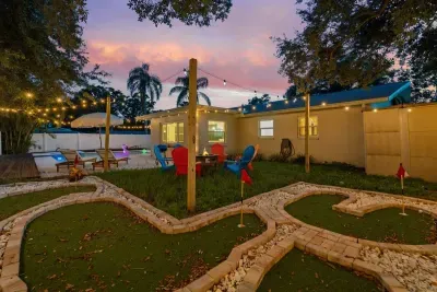 3 Family-friendly backyard with a play area, plenty of green space, and outdoor seating.