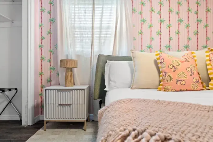 Romantic bedroom with elegant lighting and soft, neutral tones.