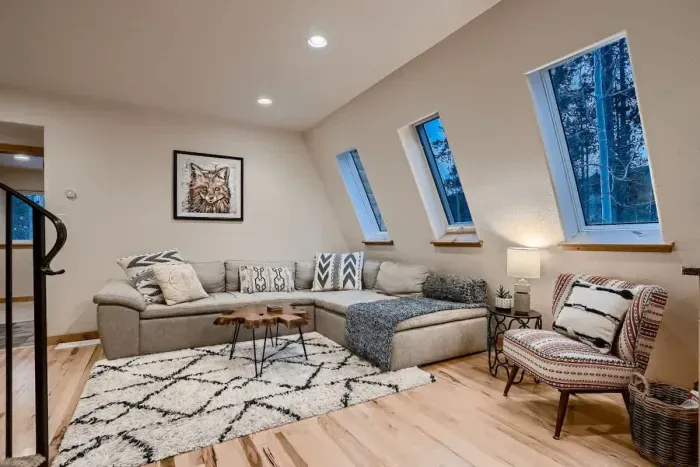 Relax in the large living room, featuring a cozy gas fireplace that adds warmth and ambiance to the space. Perfect for unwinding, the room offers plenty of seating and a welcoming atmosphere for family and guests.
