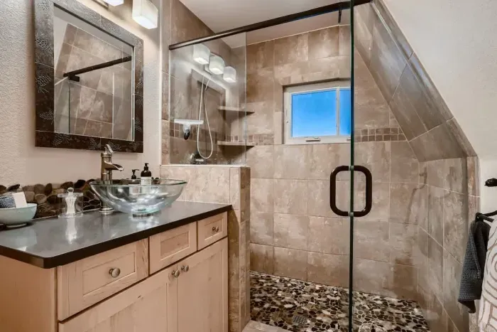Modern bathroom featuring a sleek stand-up shower, offering both style and functionality. This design provides a refreshing and efficient bathing experience, perfect for those who appreciate contemporary aesthetics and convenience.