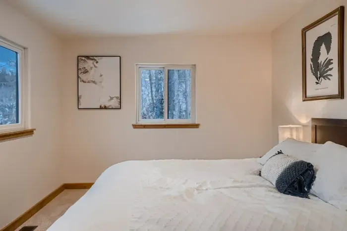 Relax in a cozy bedroom featuring a comfortable queen bed, soft linens, and a serene ambiance for a restful night's sleep. Perfect for unwinding after a day of adventure.