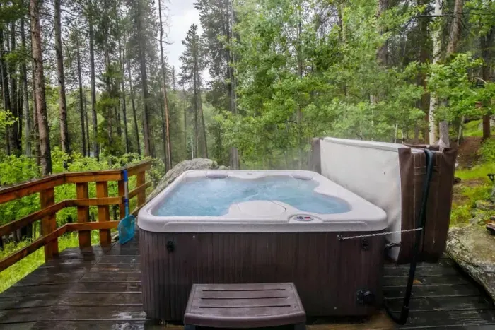 2. Relax in the private hot tub, surrounded by the serene beauty of the forest. Enjoy the soothing warmth and tranquil sounds of nature, creating the perfect escape for ultimate relaxation.