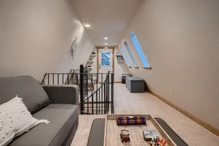 Enjoy the spacious upstairs loft, featuring a comfortable couch bed for additional sleeping space. This versatile area offers a cozy retreat with plenty of room for relaxation, perfect for guests or extra lounging.
