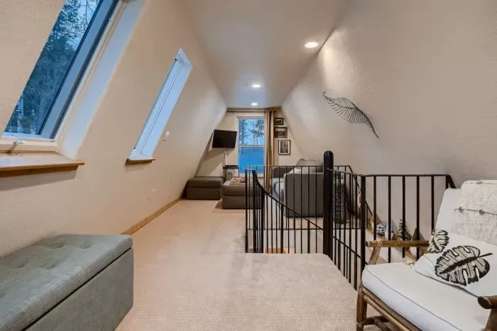 Charming upstairs loft featuring a cozy coach bed, perfect for relaxation or accommodating guests. This versatile space offers a comfortable retreat with a relaxed atmosphere, ideal for lounging, reading, or providing additional sleeping arrangements