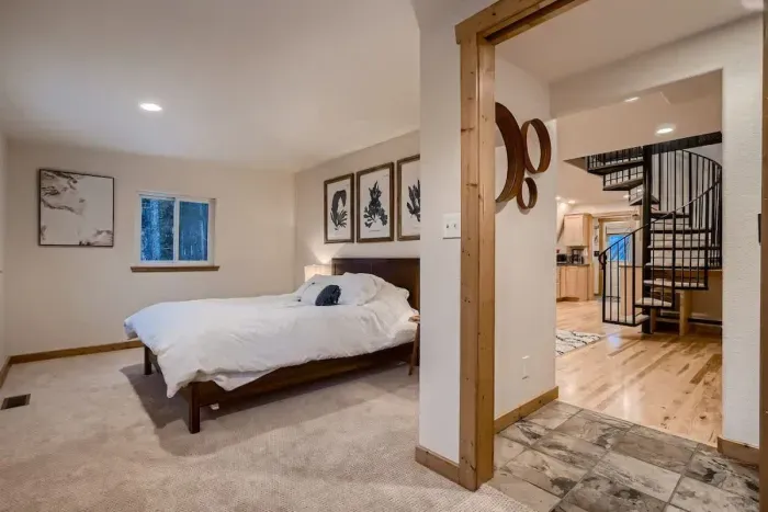 Cozy downstairs bedroom, offering easy access and comfort. This quiet retreat features a comfortable bed and tasteful décor, providing a peaceful space for relaxation with added convenience on the main floor.