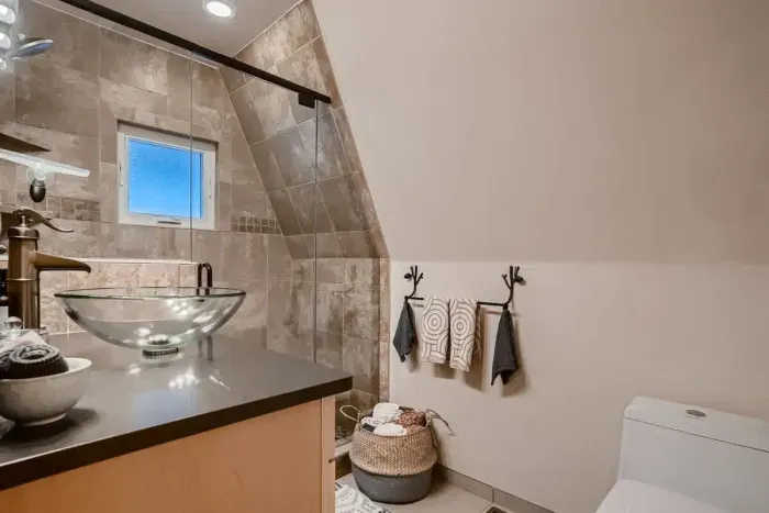 Relax in the modern bathroom featuring a sleek stand-up shower. Designed for both style and convenience, it offers a refreshing space with contemporary finishes, perfect for a quick rinse or a calming retreat.