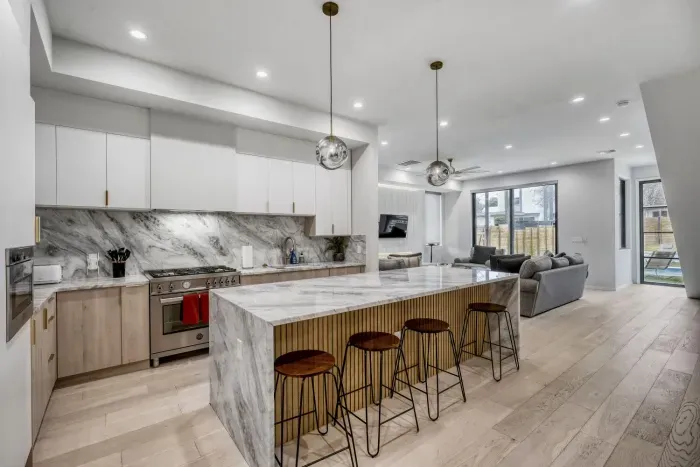 Spacious kitchen with a large island and seating, ideal for enjoying morning coffee or group meal prep.