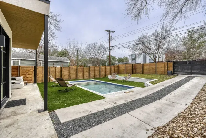 Escape to the spacious yard, offering a peaceful retreat with outdoor seating and room to relax under the open sky.