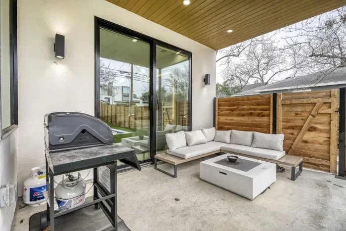 Modern covered patio, lounge chairs, and private pool area perfect for relaxing outdoors.