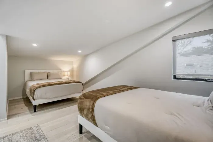 Clean, stylish bedroom offering privacy and comfort for additional guests.