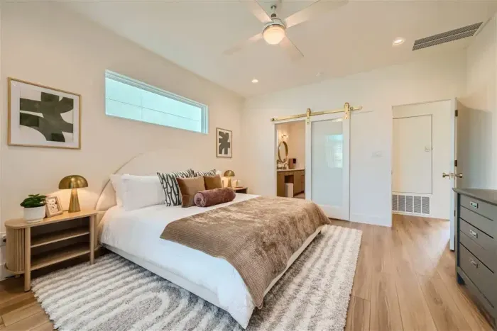 Enjoy the comfort of the primary bedroom on the main level, featuring a luxurious king-sized bed. This spacious retreat offers convenience and relaxation, with elegant furnishings and a peaceful ambiance for restful nights.