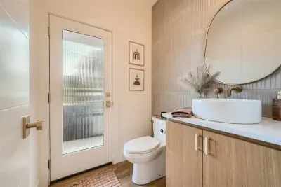Convenient half bath on the main level, offering easy access to the patio and pool area. Perfect for guests, this bathroom ensures comfort and convenience while enjoying outdoor relaxation.