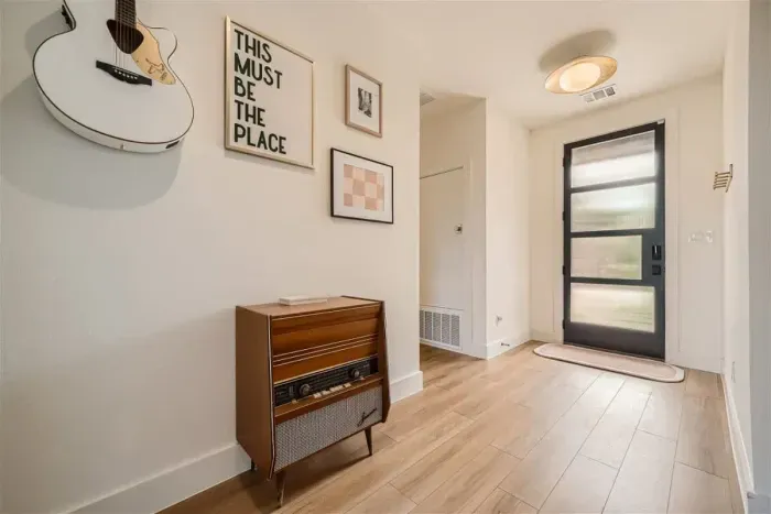 Step into a welcoming entryway, designed with style and functionality. Featuring elegant décor, soft lighting, and a cozy atmosphere, it sets the tone for the rest of the home, offering a warm and inviting first impression.