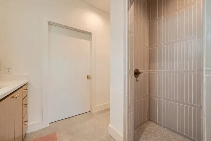 Indulge in the spacious primary bathroom, featuring dual vanities for ample space, a walk-in shower for a spa-like experience, and a private restroom for added convenience and privacy.