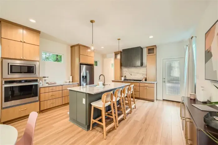 Warm and inviting kitchen with beautiful countertops and all the comforts of home.
