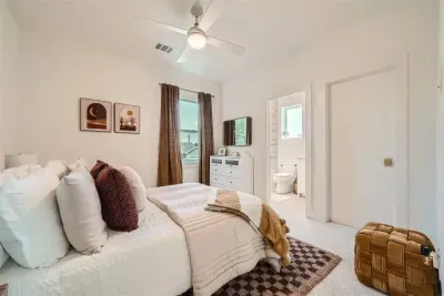 Bright and cheerful bedroom with a large bed and plenty of natural light.