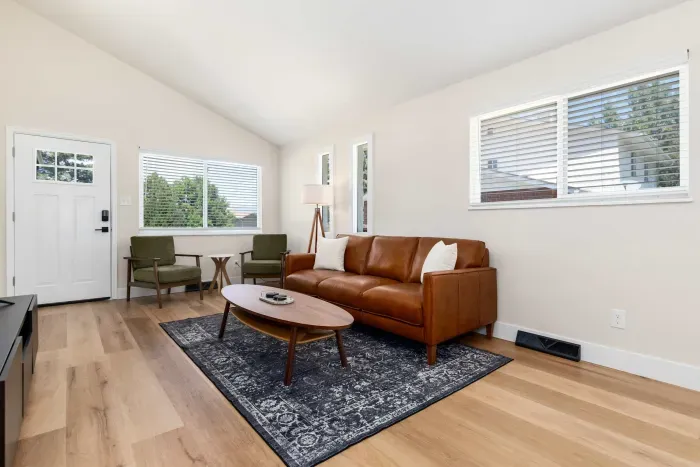 Bright and modern living room with comfy seating and smart TV.