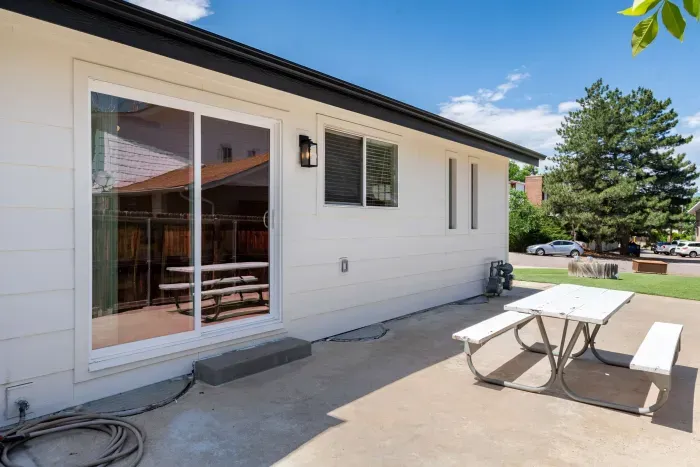 Backyard patio with outdoor dining and direct access from the living room.