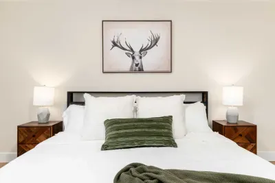 Spacious primary bedroom with plush bedding and peaceful atmosphere.