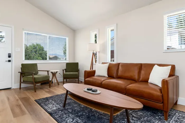 Bright and modern living room with natural light and stylish decor.