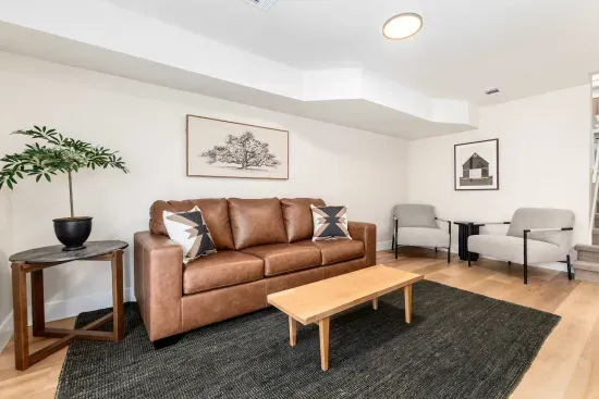 Stylish living room with sleek sofa, smart TV, and bright windows.