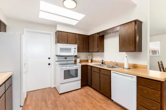 Well-equipped kitchen with modern finishes and ample counter space.