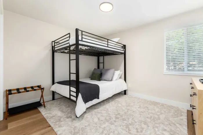 Guest bedroom with cozy twin-over-full bunk bed for flexible sleeping options.