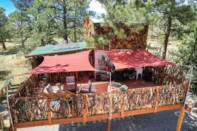 Sun sails cover the outdoor kitchen and firepit.