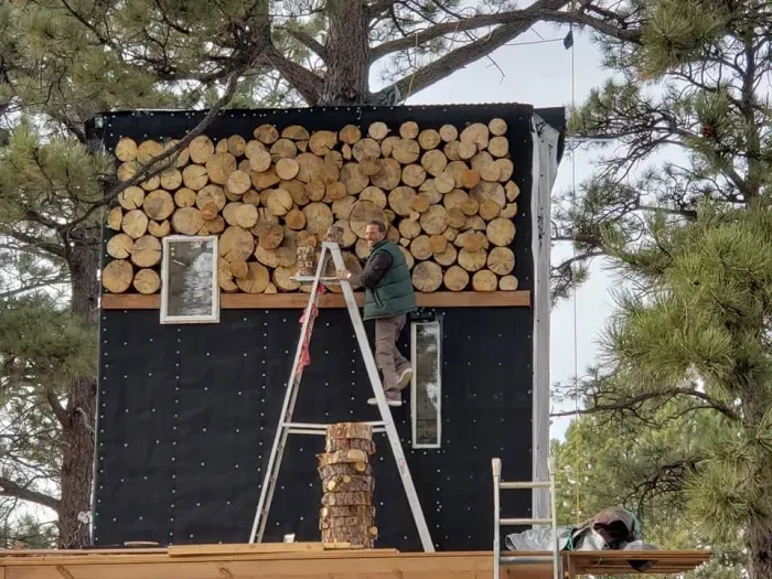 Installing "banana slice" siding from ponderosa pines on the property.
