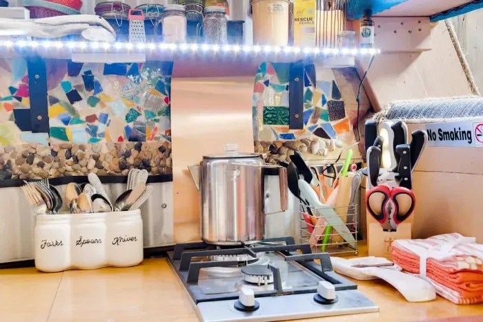 A Copper, glass, rock and stainless backsplash..