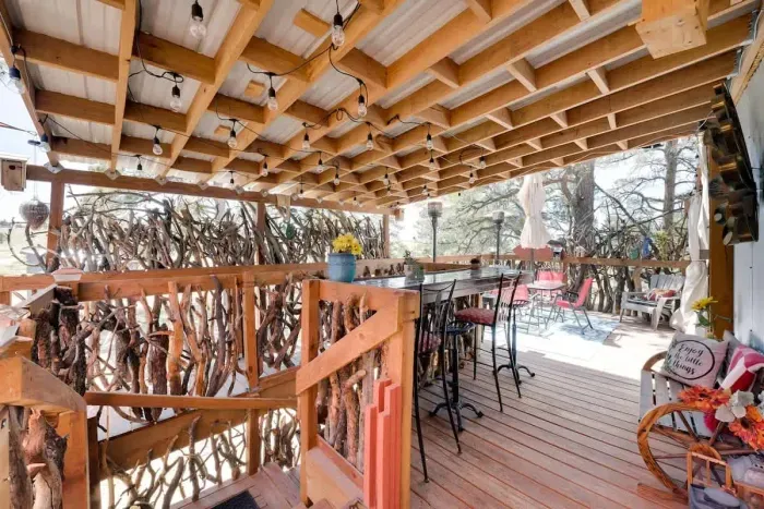 A staircase made out of branches around the property, the welcome bench and bar.  Solar lights cover the ceiling.