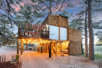The North side at night with the game room  and carport lit up