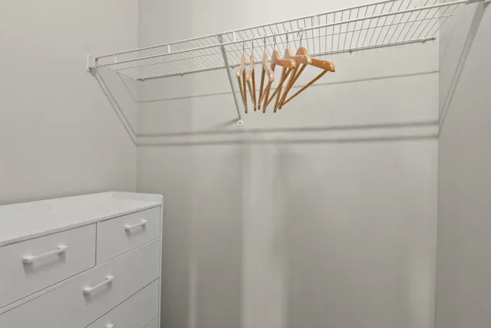Large closet with dresser and hangers for your folded and hanging items.