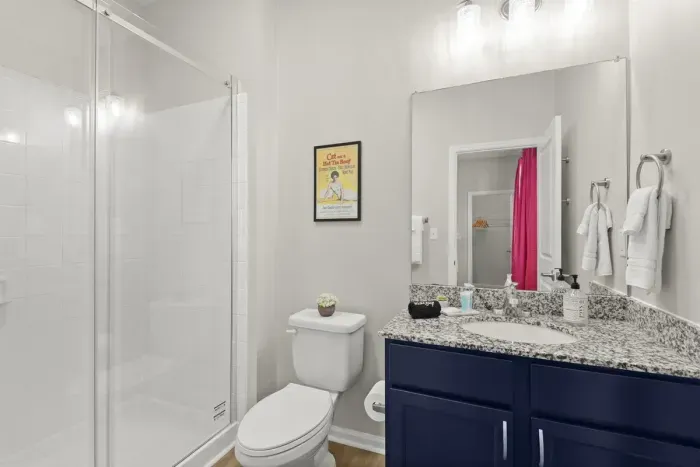 The Southern Belle’s attached, private, full bathroom with sliding glass shower door to the with carefully selected toiletries and hotel grade towels.