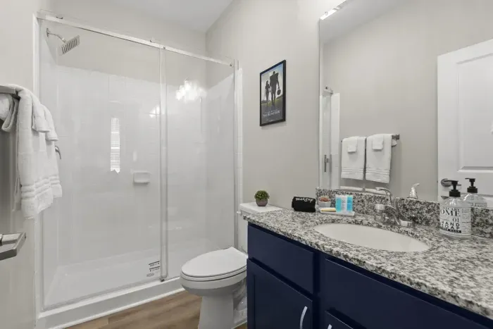 The Southern Gentleman’s attached, private, full bathroom with sliding glass shower door to the with carefully selected toiletries and hotel grade towels.