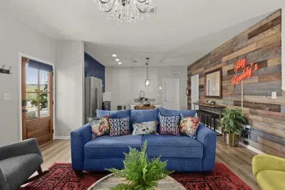 The hand crafted and stained pine door lead into the authentic living area with touches of natural wood, colorful plants and deep red Big Daddy’s sign.
