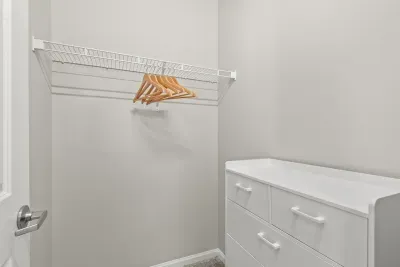 Large closet with dresser and hangers for your folded and hanging items.