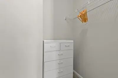 Large closet with dresser and hangers for your folded and hanging items.