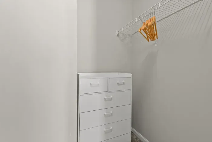 Large closet with dresser and hangers for your folded and hanging items.