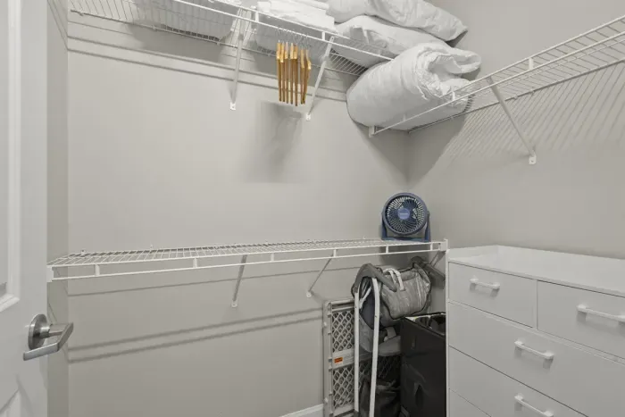 Huge closet with hangers, dresser, extra linens and baby gear.